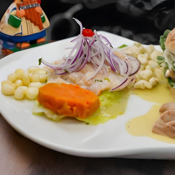 Peruvian ceviche with fish, red onions, corn, sweet potato, and a decorative figurine.